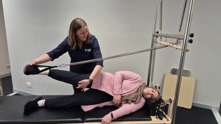 Physio working with a client using Pilates Machines