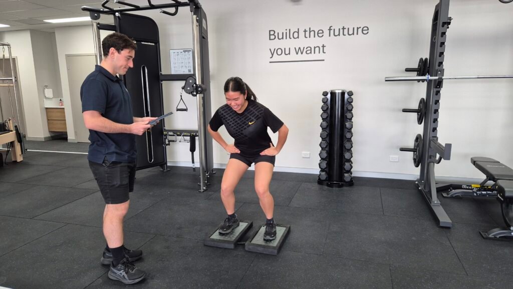 Physio assessing jumping and landing using Force Decks